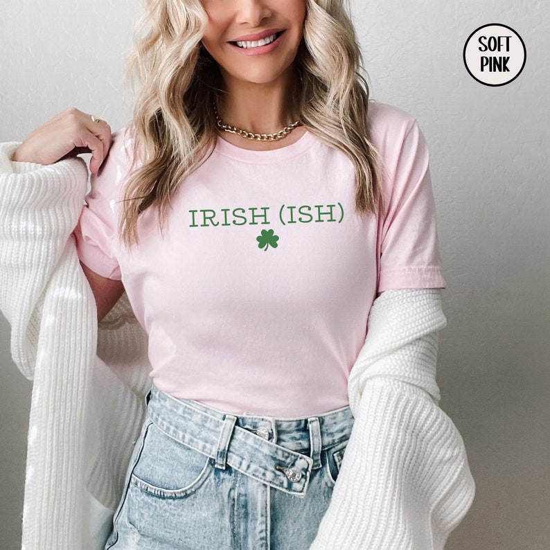 May include: A pink t-shirt with the text "IRISH (ISH)" and a green shamrock.