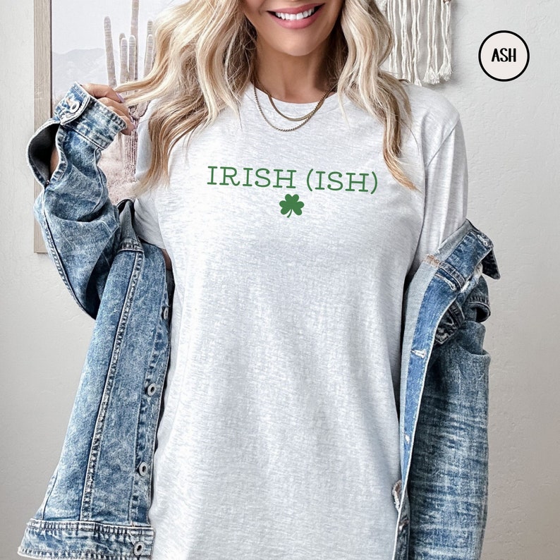 May include: A heather grey long-sleeved t-shirt with the text "IRISH (ISH)" and a green shamrock.