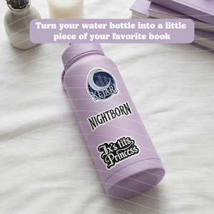 May include: A light purple water bottle with three stickers. The top sticker has a crescent moon and the word "KEJAR". The middle sticker says "NIGHTBORN". The bottom sticker says "Ix's tits, Princess". The text "Turn your water bottle into a little piece of your favorite book" is above the bottle.