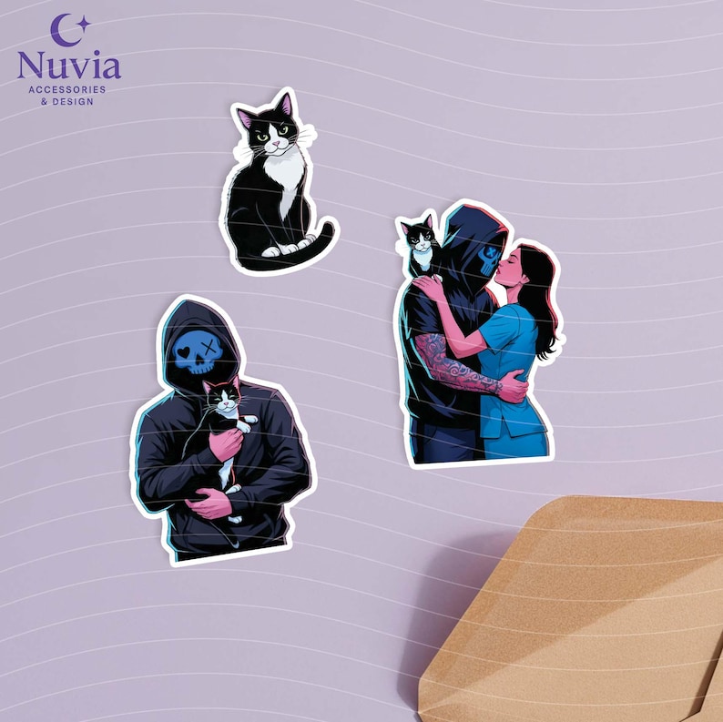 May include: Set of stickers featuring illustrations of cats and figures in hoodies. One sticker shows a black and white cat. Another shows a person in a black hoodie holding a cat. The third sticker shows a couple embracing and kissing.