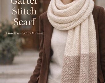 May include: A woman wearing a cream-colored Garter Stitch Scarf with a fringed edge. The scarf has a two-tone design, with a light cream color at the top and a brown color at the bottom. The text "Garter Stitch Scarf" is visible.