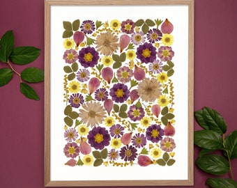 May include: A framed print of a pressed flower arrangement. The flowers are a mix of purple, pink, yellow, and white. The flowers are arranged in a random pattern.