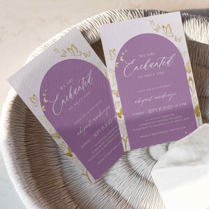 May include: A purple and white invitation with gold butterflies and the text "We are Enchanted to meet you" and "Abigail Raekenpe" with the date and time of the event. The event is at the Rose Garden Inn on Sunday, 15 September 2023 at 3 PM.
