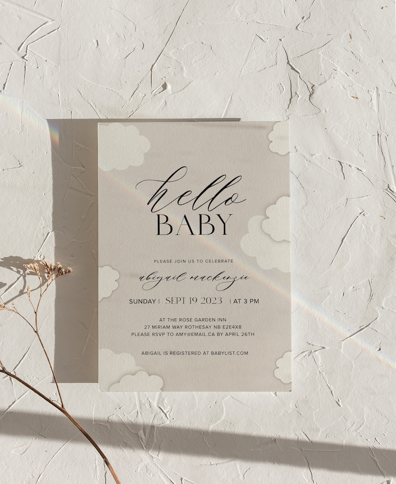 May include: A baby shower invitation with a white background and clouds. The text reads "hello baby" in black cursive font. The invitation includes the name "abigail mackinzu", the date "Sunday, Sept 19, 2023", the time "at 3 pm", the location "at the Rose Garden Inn", the address "27 Miriam Way, Rothesay NB E2E4X8", and the RSVP information "Please RSVP to amy@email.ca by April 26th". The bottom of the invitation reads "Abigail is registered at babylist.com".