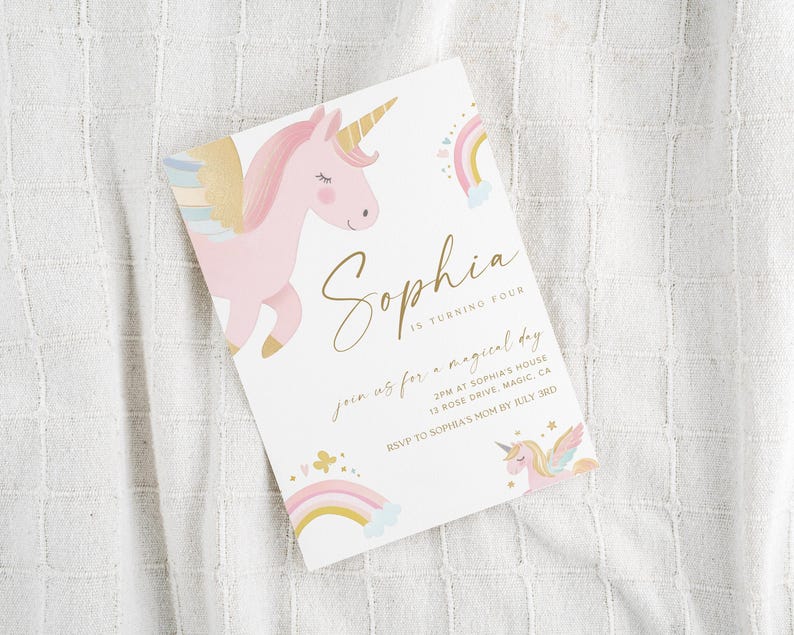 May include: A white invitation card featuring a pink unicorn with a golden horn and wings, a rainbow, and the name "Sophia" in gold script. The text reads "is turning four" and invites guests to a magical day.