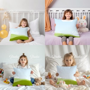 May include: Four children are sitting on beds holding decorative pillows with a light blue background and a green grass design at the bottom. The pillows are white with a light blue center and a green grass design at the bottom.