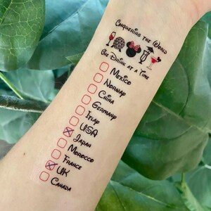 May include: A temporary tattoo featuring the text Conquering the World and One Drink at a Time, accompanied by icons of a wine glass, a globe, mouse ears, and cocktails. A checklist includes Mexico, Norway, China, Germany, Italy, USA, Japan, Morocco, France, UK, and Canada.