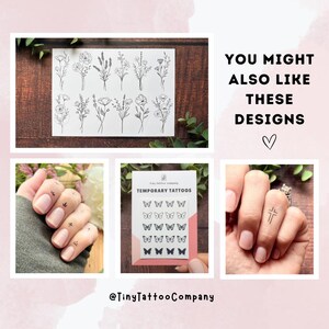 Puede incluir: Una colecci&oacute;n de hojas de tatuajes temporales con dise&ntilde;os de l&iacute;neas negras de flores silvestres, mariposas y una cruz. El texto dice "YOU MIGHT ALSO LIKE THESE DESIGNS", "TEMPORARY TATTOOS" y el usuario "@TinyTattooCompany".