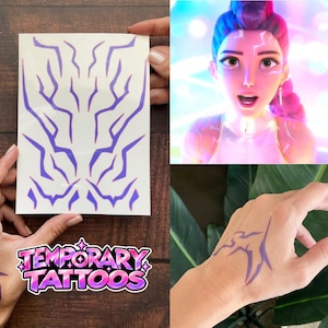 Puede incluir: Una hoja de tatuajes temporales de color morado con patrones dentados similares a rayos. El diseño incluye múltiples formas individuales que se pueden aplicar sobre la piel, como se muestra con la marca morada en una mano.