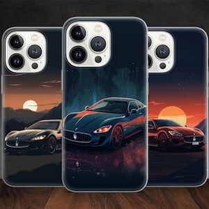 May include: Three phone cases with different designs featuring a sports car in a sunset scene. The cases are clear and show the phone screen through the back.