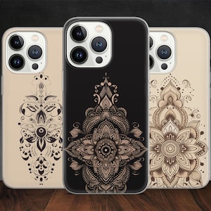 May include: Three phone cases with a mandala design. The cases are black, gold, and white.