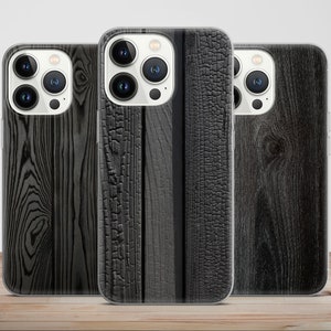 May include: Three clear phone cases with different wood grain designs. The cases are all black and white and have a wood grain pattern. The cases are all for the same model of phone.
