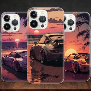 May include: Three phone cases with a design of a sports car on a beach at sunset. The cases have a clear border and a design in shades of orange, purple, and black. The cars have spoilers and are parked on the sand.