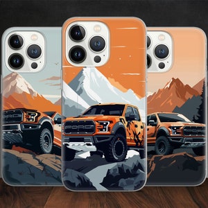 May include: Three phone cases with a design of an orange Ford pickup truck driving through a snowy mountain landscape. The cases are clear and show the phone's camera lenses.