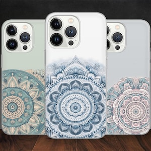 May include: Three phone cases with mandala designs. The cases feature intricate patterns in shades of blue, teal, and pink. The cases are displayed against a dark background, showcasing the detailed artwork and colour variations.