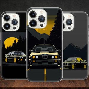 May include: Three clear phone cases with black and yellow designs featuring a black BMW car. The cases have a black background with a yellow moon and trees in the background. The car is in the foreground and is driving on a yellow road. The cases are for iPhone.