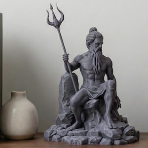 May include: A gray statue of a seated man with a long beard, holding a trident. The statue is on a rocky base. The statue is on a wooden shelf with books and a small vase.