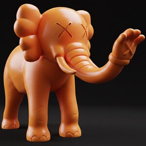May include: Orange figurine of an elephant with crossed-out eyes and a raised hand. The elephant has large ears and a trunk. The figurine is a solid color and stands on four legs. The background is black.