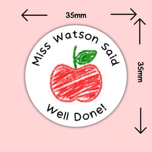 May include: A white round sticker, 35mm in diameter, featuring a red apple illustration with a green leaf. The text "Miss Watson said" and "Well Done!" are printed in black around the apple.