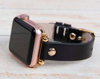 May include: A rose gold Apple Watch with a black leather band and gold accents. The band has a stitched design and a buckle closure.