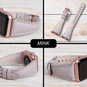 May include: A pale grey leather watch strap with a rose gold buckle and watch case. The watch strap is shown in various views, including a close-up of the buckle and the strap detached. The word "MINK" is displayed in a black rectangle.