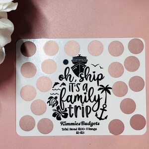 May include: A white card with a pink and white polka dot pattern. The card has a black graphic of a cruise ship with the text "oh ship it's a family trip" and an anchor. The card also has the text "Kimmies Budgets Total Saved &pound;100 - Range &pound;2-&pound;15".