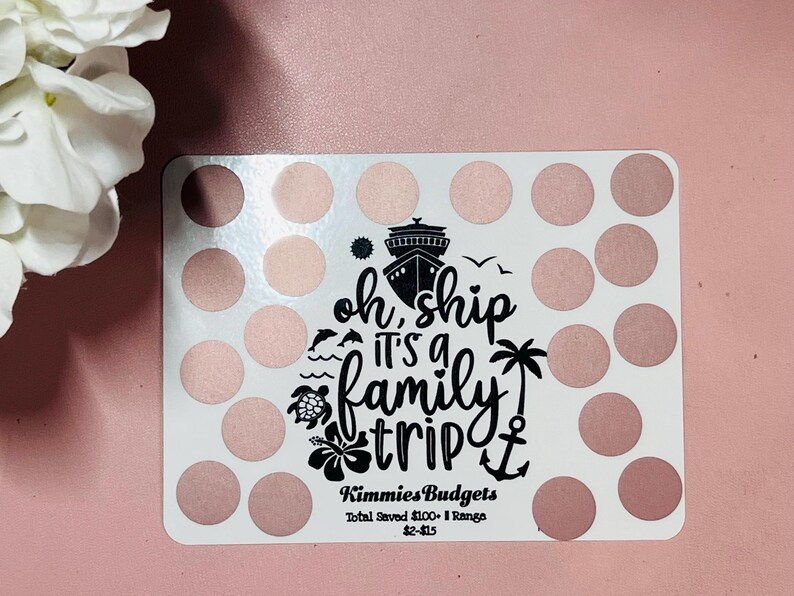 May include: A white card with a pink and white polka dot pattern. The card has a black graphic of a cruise ship with the text "oh ship it's a family trip" and an anchor. The card also has the text "Kimmies Budgets Total Saved &pound;100 - Range &pound;2-&pound;15".