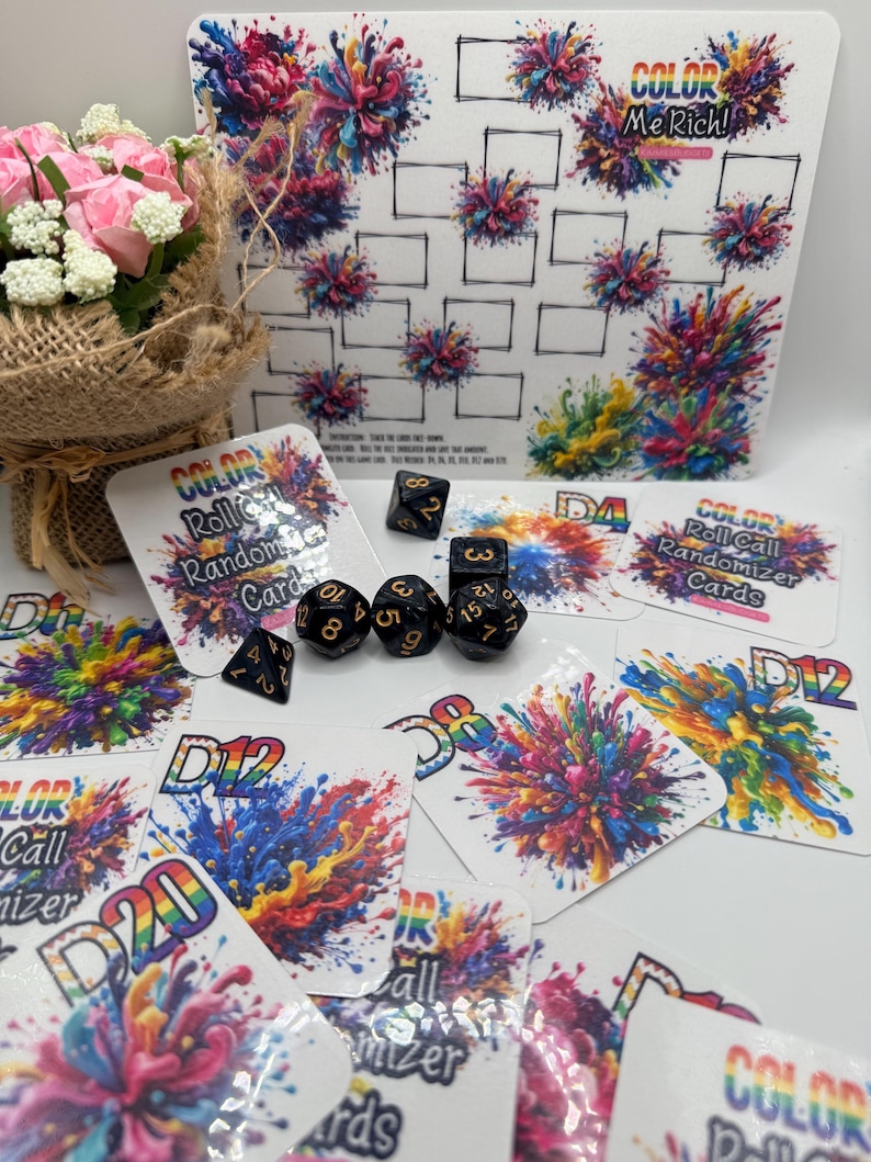 May include: A collection of colorful gaming accessories, including dice and cards. The cards feature vibrant abstract art and text that reads "COLOR Roll Call Randomizer Cards". A white board with a grid and the text "COLOR Me Rich!" is also present.