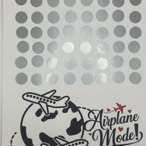 May include: A sheet of silver sticker dots with a black and white illustration of two airplanes flying around a globe. The text "Airplane Mode!" is written in a stylized font with red hearts. The text "Amounts Range $1-30" is written below the illustration.