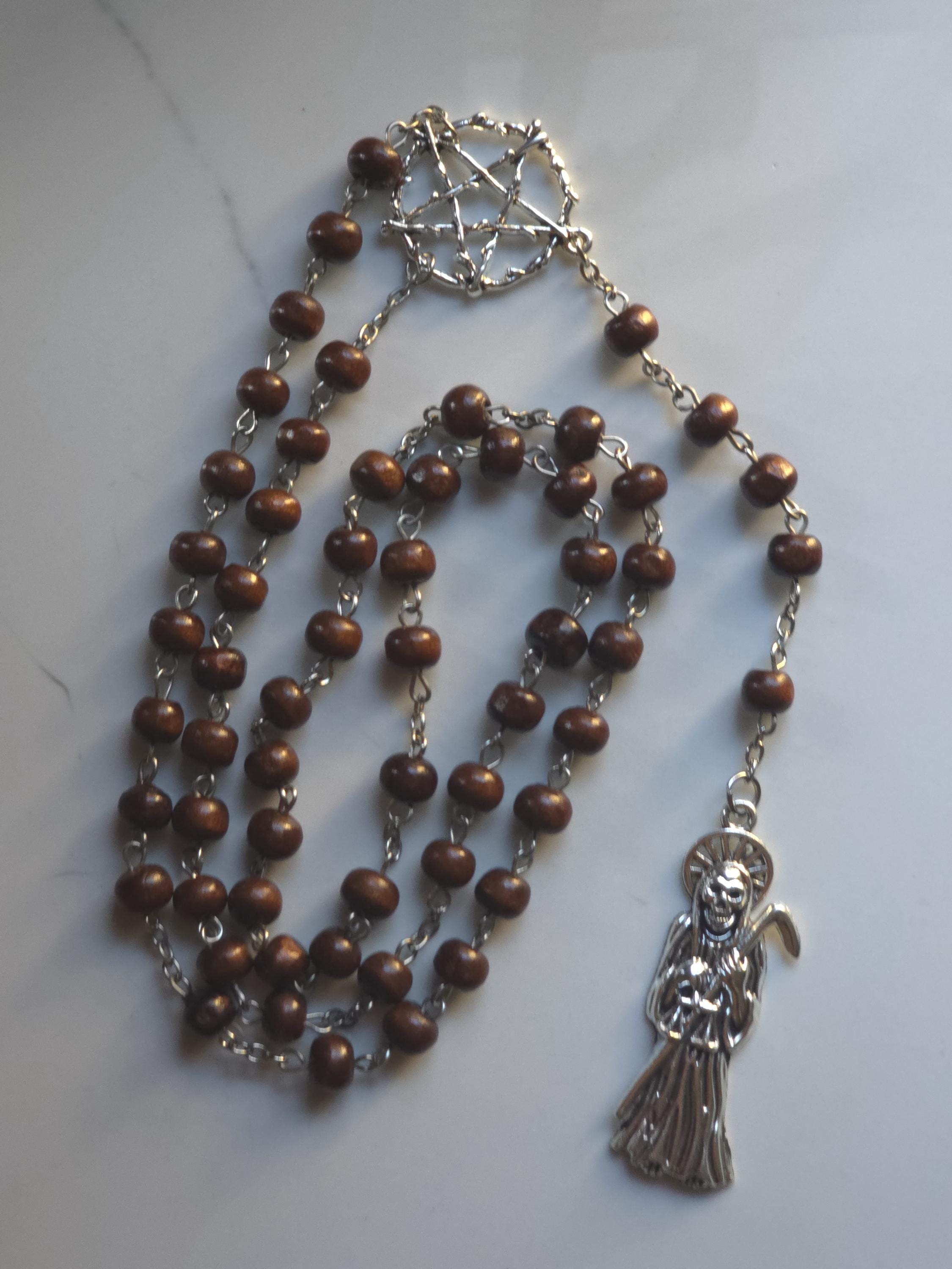 Santa Muerte Rosary: Brown wooden beads and Santa muerte pendant.