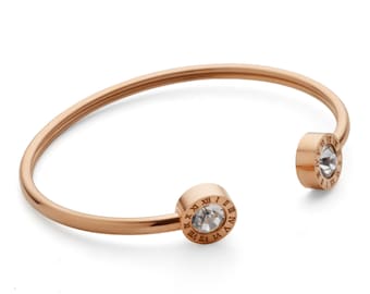 Gold plated bracelet stainless steel in roman letters. Silver stones.