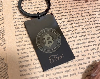 May include: Black metal keychain with a gold Bitcoin logo and the name "Toni" engraved on it.