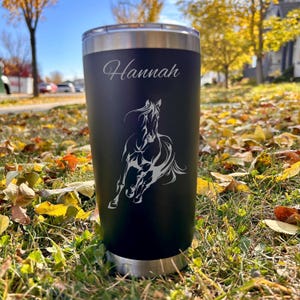 May include: Black stainless steel tumbler with a horse design and the name "Hannah" engraved on the side.