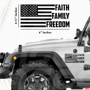 May include: Black and white decal featuring the American flag and the words "FAITH FAMILY FREEDOM." The decal measures 8 inches wide and 3.71 inches high. It is shown applied to a white vehicle.