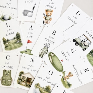 May include: A collection of white rectangular cards featuring golf-themed alphabet illustrations. Each card displays a letter, the phrase is for, and a corresponding word like Iron, Junior, Ace, Birdie, Links, Caddie, Greens, or Out of Bounds.