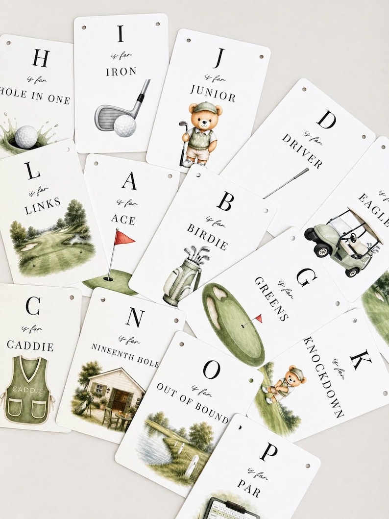 May include: A collection of white rectangular cards featuring golf-themed alphabet illustrations. Each card displays a letter, the phrase is for, and a corresponding word like Iron, Junior, Ace, Birdie, Links, Caddie, Greens, or Out of Bounds.