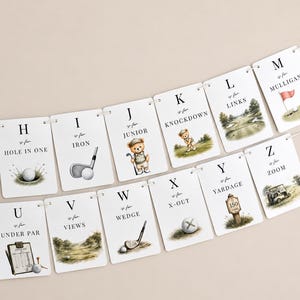 May include: A decorative banner featuring rectangular cards with golf-themed illustrations and alphabet letters from H to M and U to Z. Each card displays a letter, the phrase 'is for', and a golf term like 'Hole in One' or 'Yardage' with watercolour art.