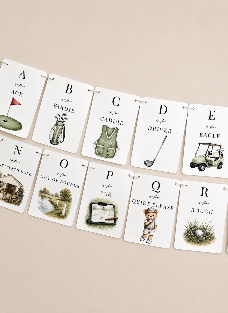 May include: A decorative banner featuring white rectangular cards strung together, each displaying a letter of the alphabet from A to R with golf-themed illustrations and text such as A is for ACE, B is for BIRDIE, C is for CADDIE, D is for DRIVER, E is for EAGLE, N is for NINETEENTH HOLE, O is for OUT OF BOUNDS, P is for PAR, Q is for QUIET PLEASE, and R is for ROUGH.