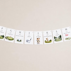 May include: A decorative banner featuring a series of white rectangular cards, each displaying a letter from F to M, golf-themed illustrations, and text including 'F is for Fairway', 'G is for Greens', 'H is for Hole in One', 'I is for Iron', 'J is for Junior', 'K is for Knockdown', 'L is for Links', and 'M is for Mulligan'.