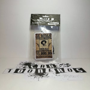 May include: A brown and white car air freshener with a vintage wanted poster design. The poster features a drawing of Pancho Villa with the text "Se Busca Vivo o Muerto" and "Recompensa $5,000.00".