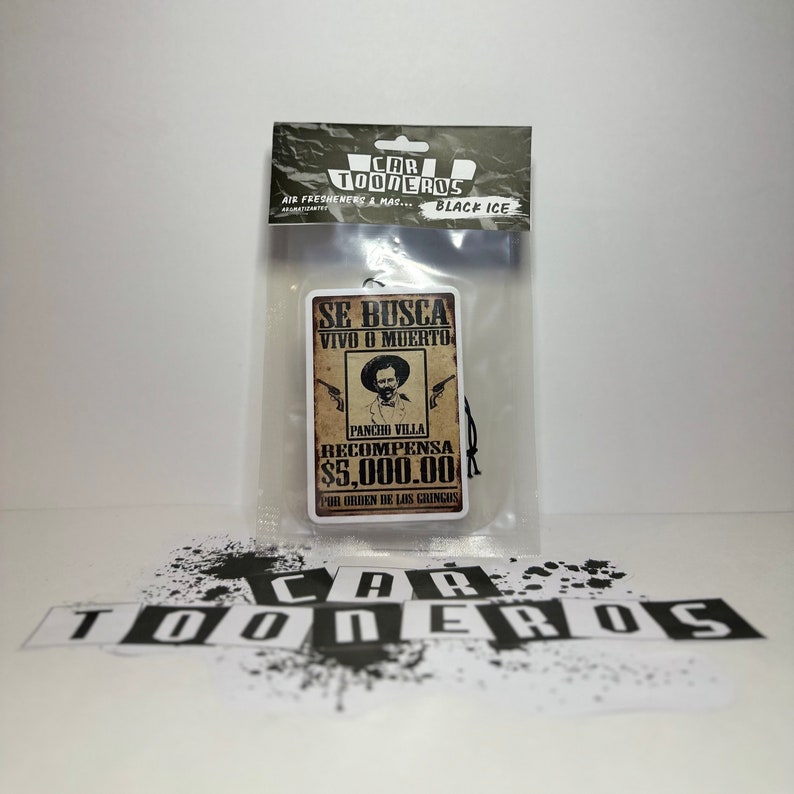 May include: A brown and white car air freshener with a vintage wanted poster design. The poster features a drawing of Pancho Villa with the text "Se Busca Vivo o Muerto" and "Recompensa $5,000.00".