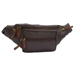 May include: A brown leather fanny pack with multiple zipped compartments. The bag features gold-coloured zips with red accents. The fanny pack is designed to be worn around the waist and has an adjustable strap.