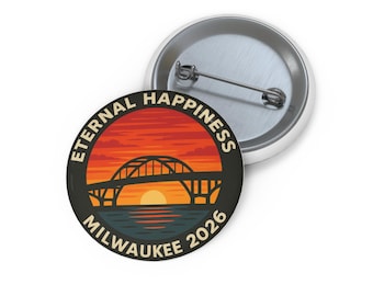 May include: A round button with a graphic of a bridge over water at sunset. The text "ETERNAL HAPPINESS MILWAUKEE 2026" is printed around the image. The button is white with a metal pin back.
