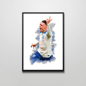 May include: Framed art print featuring a stylized illustration of a soccer player in a white jersey with blue accents, celebrating a goal. The artwork has a watercolor effect with blue and gray brushstrokes, set against a white background.