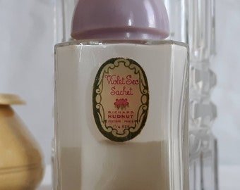 Vintage Violet Sec Powder Sachet. Richard Hudnut. Clear glass Jar With violet rounded lid. No box. Is 1/2 full of powder.