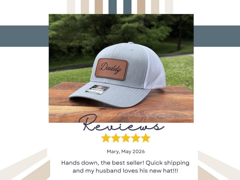 May include: A light gray baseball cap with a white mesh back and a brown rectangular leather patch on the front. The patch features the word Daddy in a black cursive script. A small black sticker is visible on the brim of the cap.