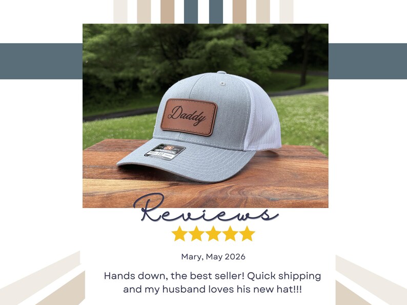 May include: A light gray baseball cap with a white mesh back and a rectangular brown leather patch on the front. The patch features the word Daddy in a black cursive script. A small black sticker is visible on the brim of the cap.