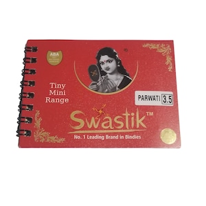 May include: A red spiral-bound booklet with the text "Tiny Mini Range" and "Swastik" in gold lettering. The booklet features an image of a woman and the text "No. 1 Leading Brand in Bindies". The booklet is labeled "PARWATI 3.5".