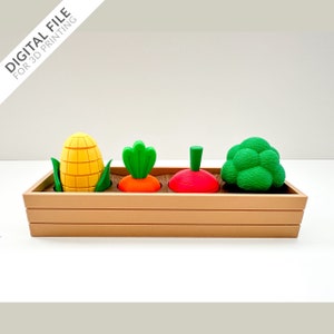 以下が含まれることがあります： 4つの区画に分かれた木製のプランターボックス。各区画には異なる野菜が入っています。区画には、黄色のトウモロコシの穂、緑色のニンジン、赤色のラディッシュ、緑色のブロッコリーが入っています。