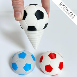 May include: Three soccer balls, one black and white, one blue and white, and one red and white. The black and white soccer ball is on a white spiral stand.  DIGITAL FILE FOR 3D PRINTING